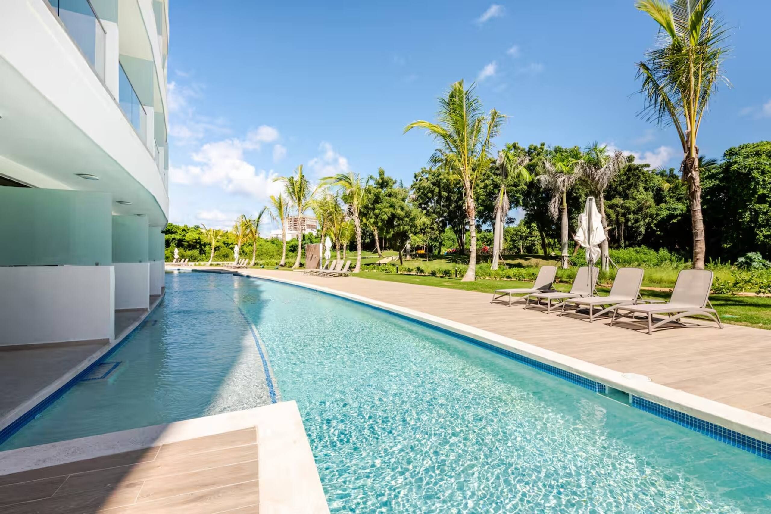 Pool running directly along the ground-floor swim-up terraces at Cana Rock Universe